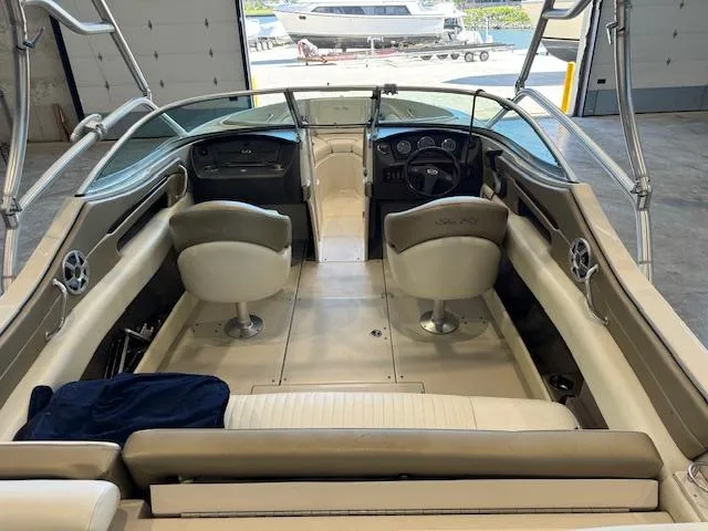 Slide: The Image of 2007 Sea Ray 230 Select boat interior with dual captain chairs and spacious seating. - 2