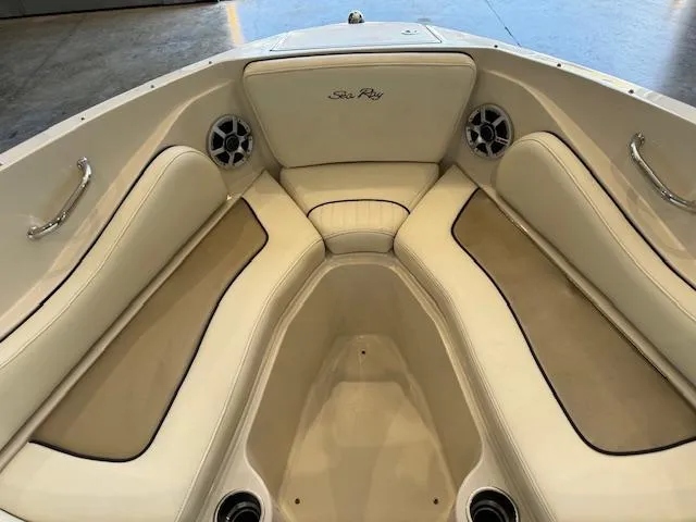 Slide: The Image of 2007 Sea Ray 230 Select boat interior with beige seating and built-in speakers. - 5