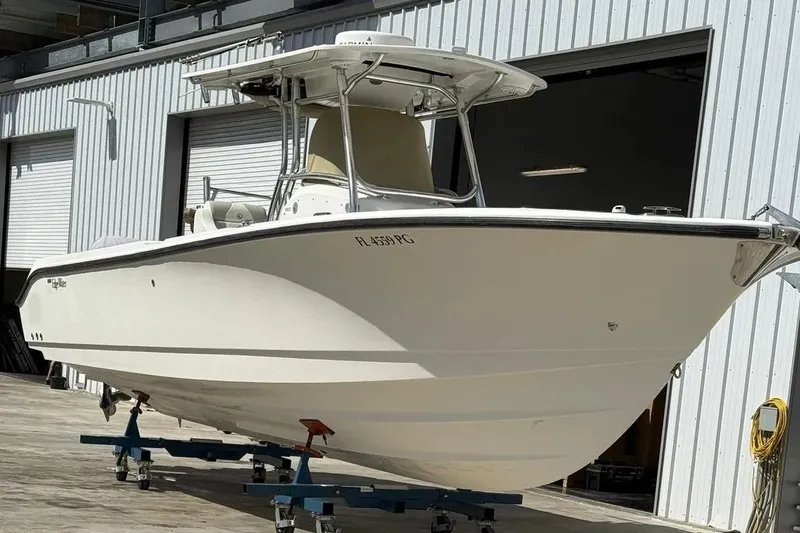 The Image of 2010 Edgewater 318CC boat on stands outside a warehouse. - 1