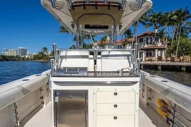 Slide: The Image of Edgewater 318CC 2010 boat interior with storage, set against a waterfront backdrop. - 15