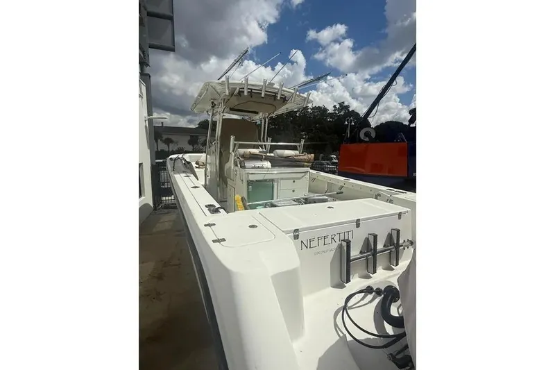 Slide: The Image of 2010 Edgewater 318CC boat docked under cloudy sky. - 25
