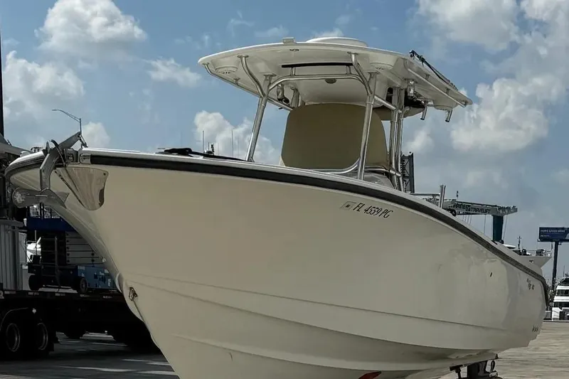 Slide: The Image of 2010 Edgewater 318CC boat docked under a cloudy sky. - 4