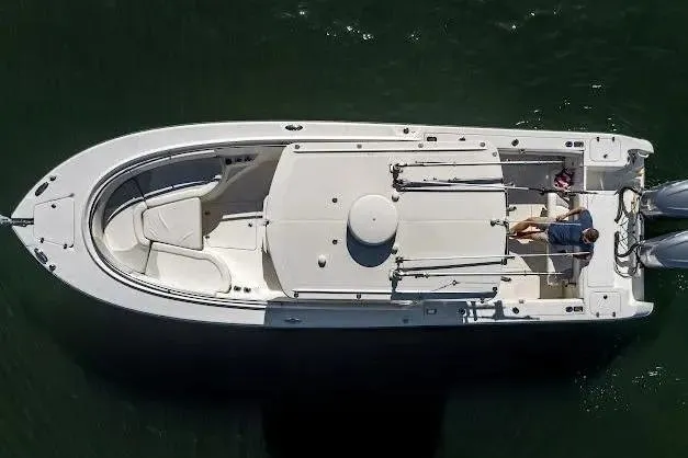 Slide: The Image of Aerial view of a 2010 Edgewater 318CC boat on water, featuring spacious deck layout. - 9