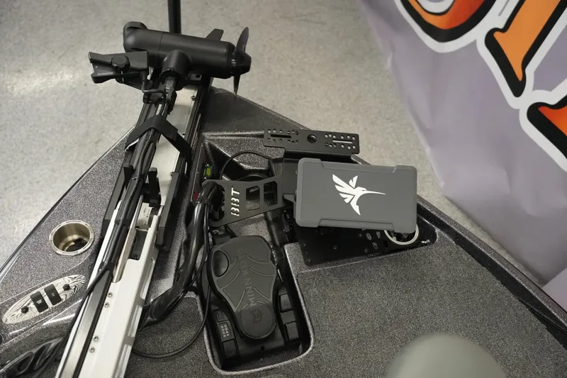 Slide: The Image of 2025 Bass Cat Puma STS boat dashboard with steering wheel and control panel. - 11