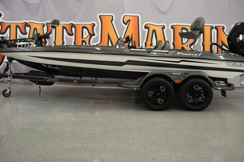 Slide: The Image of 2025 Bass Cat Puma STS boat on display in a showroom setting. - 2