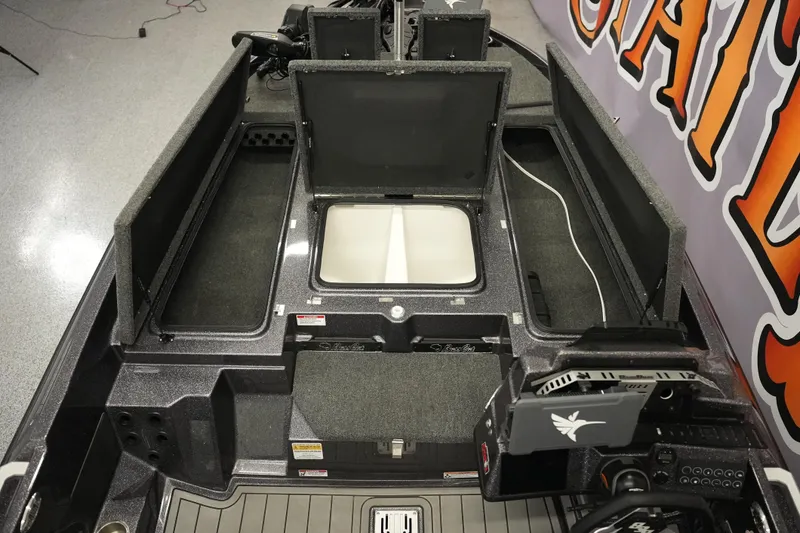 Slide: The Image of 2025 Bass Cat Puma STS boat interior with logo and storage compartment. - 21
