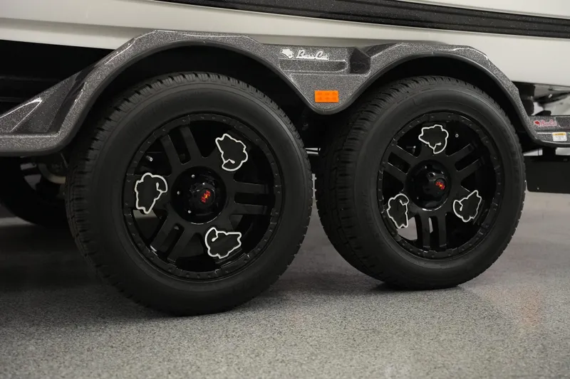 Slide: The Image of 2025 Bass Cat Puma STS fishing boat deck with storage compartments and trolling motor. - 5