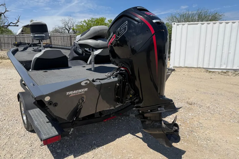 Slide: The Image of 2018 Tracker Pro Team 190 TX boat with Mercury engine, parked outdoors. - 2
