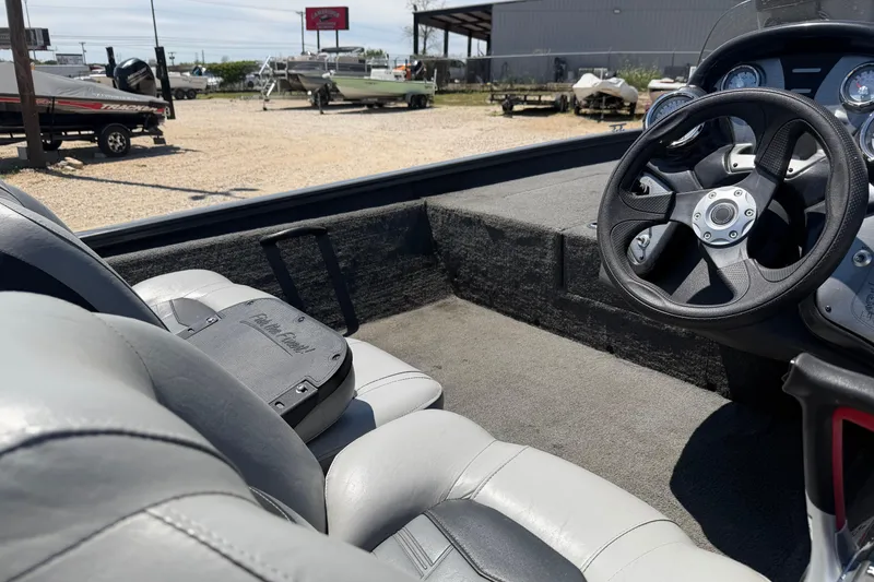 Slide: The Image of 2018 Tracker Pro Team 190 TX boat interior with steering wheel and seats. - 7