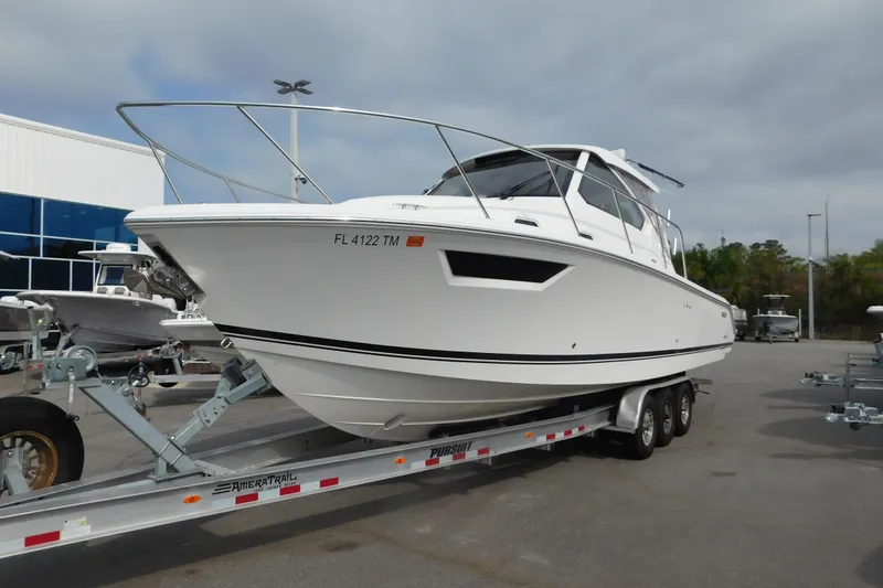 The Image of 2023 Pursuit OS 325 Offshore boat on trailer in parking lot. - 0