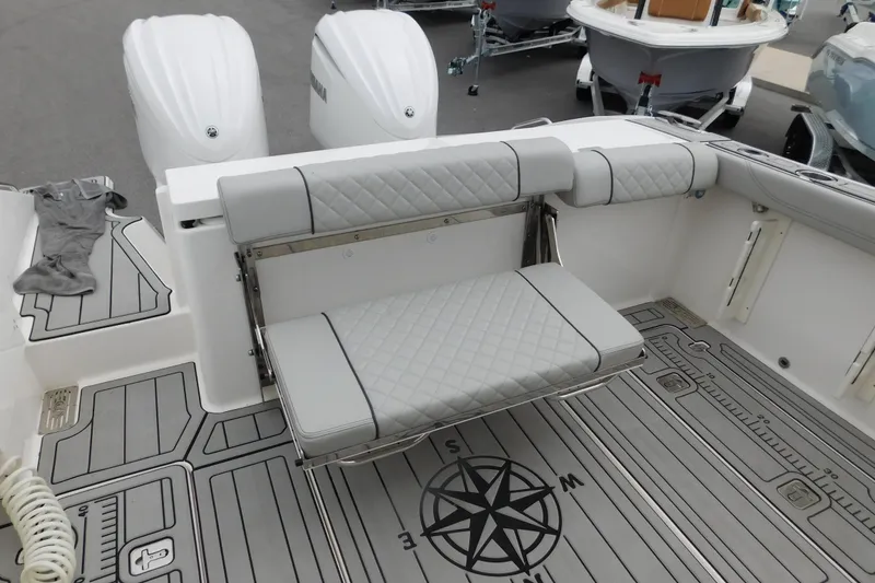 Slide: The Image of 2023 Pursuit OS 325 Offshore boat with foldable seating and dual outboard engines. - 10