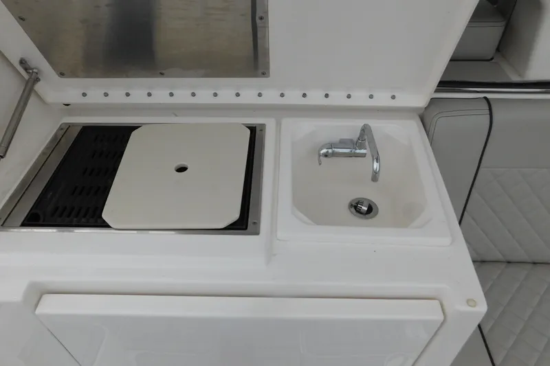 Slide: The Image of 2023 Pursuit OS 325 Offshore boat sink and grill station. - 15