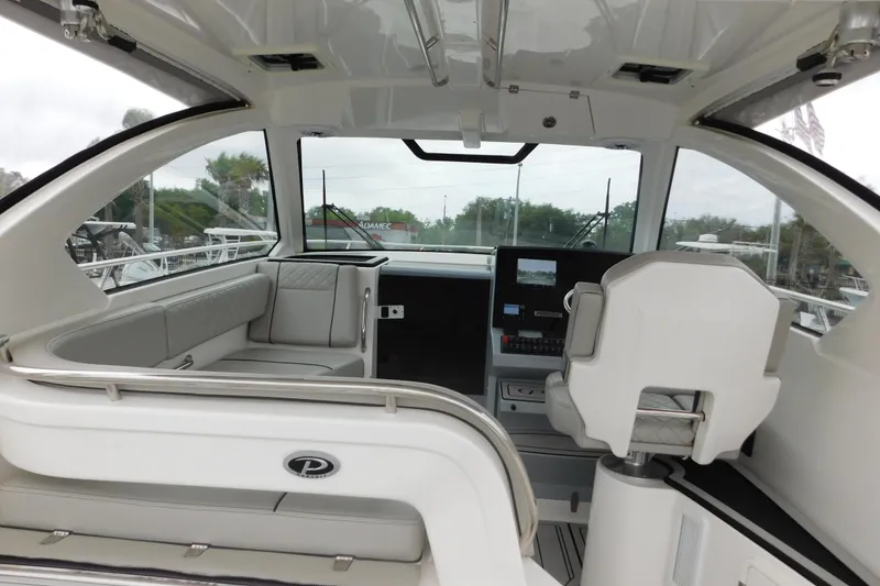Slide: The Image of 2023 Pursuit OS 325 Offshore boat interior with modern seating and navigation console. - 18