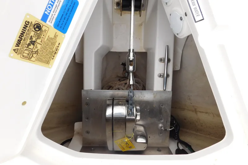 Slide: The Image of Anchor compartment of 2023 Pursuit OS 325 Offshore boat with warning labels. - 23