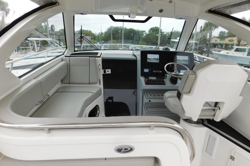 Slide: The Image of 2023 Pursuit OS 325 Offshore boat interior with modern helm and seating area. - 24