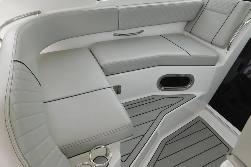 Slide: The Image of 2023 Pursuit OS 325 Offshore boat interior with gray cushioned seating and sleek design. - 27