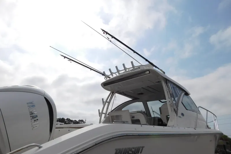 Slide: The Image of 2023 Pursuit OS 325 Offshore boat with fishing rods and Yamaha engine. - 3