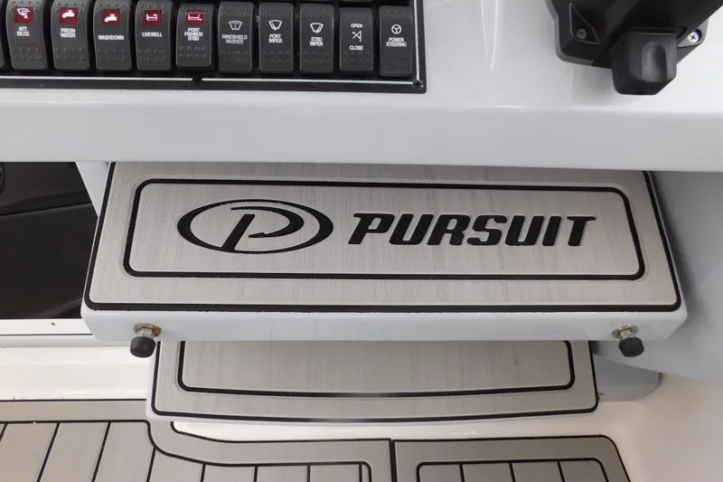 Slide: The Image of Control panel of 2023 Pursuit OS 325 Offshore boat with branded step. - 35