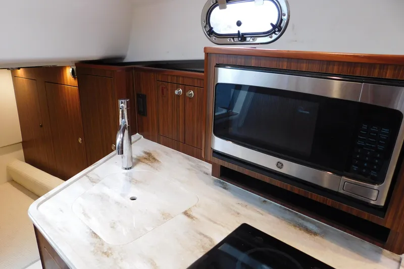 Slide: The Image of 2023 Pursuit OS 325 Offshore yacht interior with modern kitchen amenities. - 46
