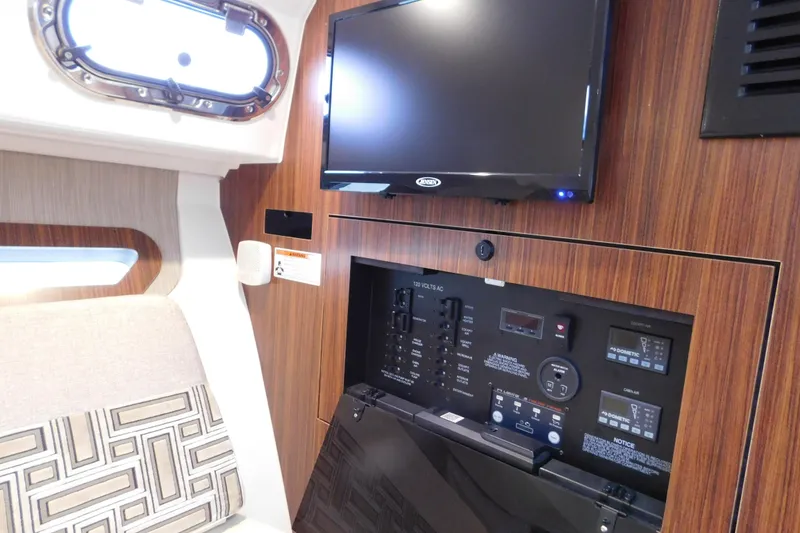 Slide: The Image of Interior of 2023 Pursuit OS 325 Offshore boat with control panel and mounted TV. - 48