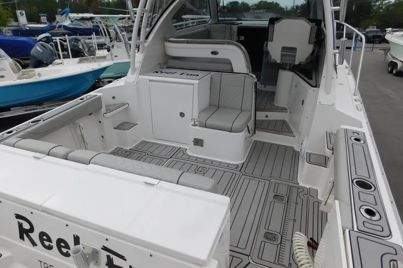 Slide: The Image of 2023 Pursuit OS 325 Offshore boat interior with seating and deck view. - 8