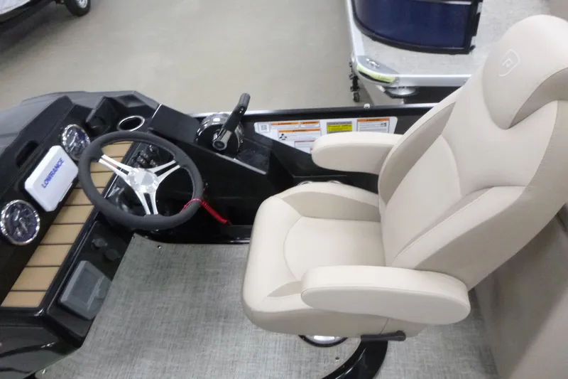 Slide: The Image of 2026 Premier 230 Sunsation RF - CL boat helm with steering wheel and captain's chair. - 8