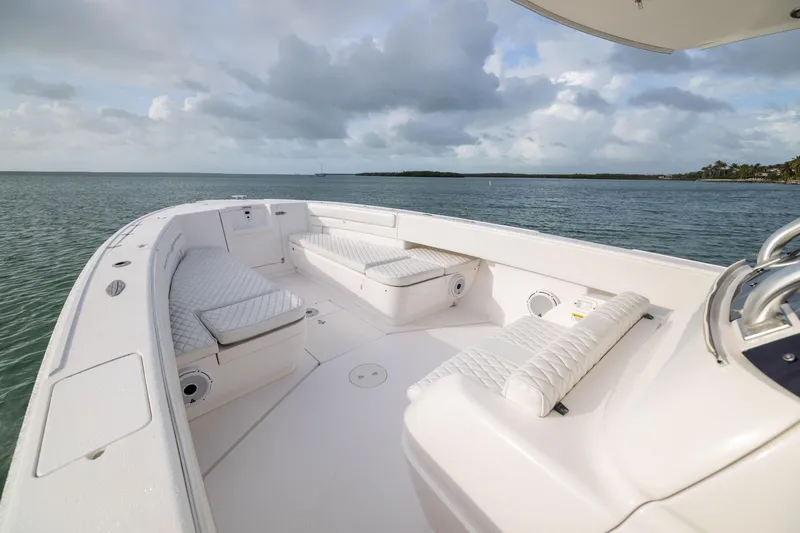 Slide: The Image of 2011 Intrepid 370 Center Console boat with cushioned seating on calm waters. - 12