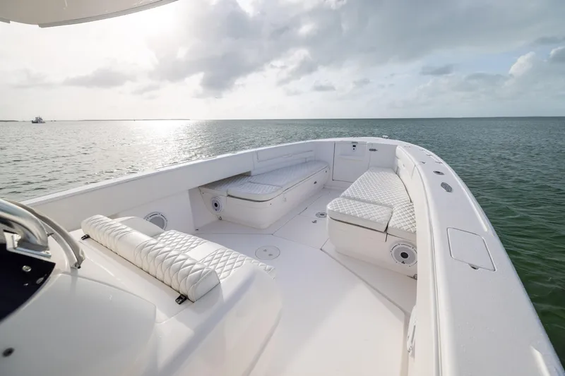 Slide: The Image of 2011 Intrepid 370 Center Console boat with white seating, on calm ocean waters. - 13