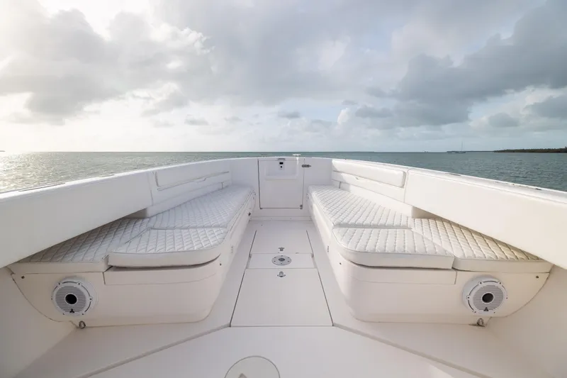 Slide: The Image of 2011 Intrepid 370 Center Console boat interior with cushioned seating, ocean view. - 14
