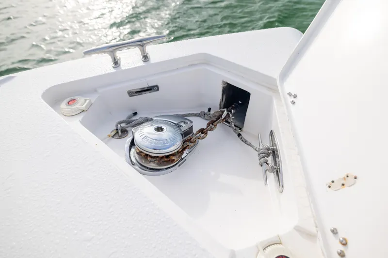 Slide: The Image of Anchor compartment of 2011 Intrepid 370 Center Console boat with chain and winch. - 15