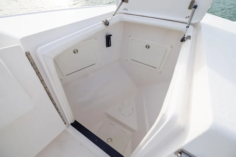 Slide: The Image of Open storage compartment on a 2011 Intrepid 370 Center Console boat. - 16