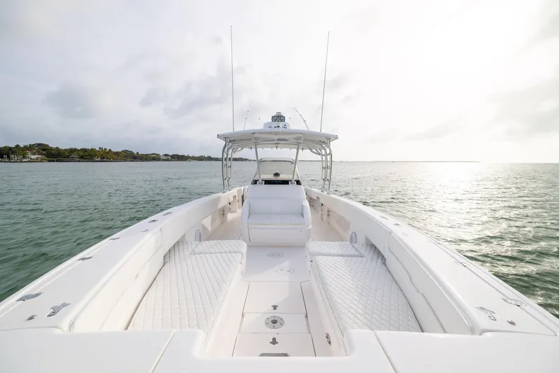Slide: The Image of 2011 Intrepid 370 Center Console boat on calm water under cloudy sky. - 17