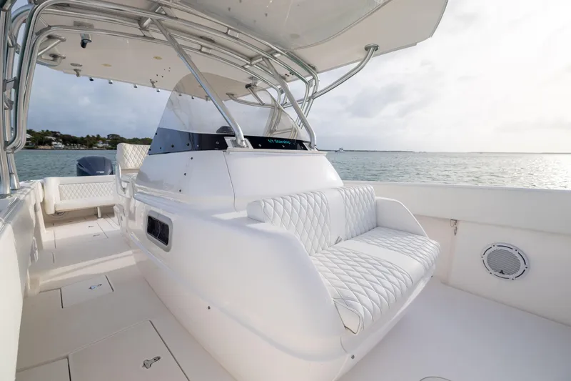 Slide: The Image of 2011 Intrepid 370 Center Console boat with white seating, on calm water. - 19