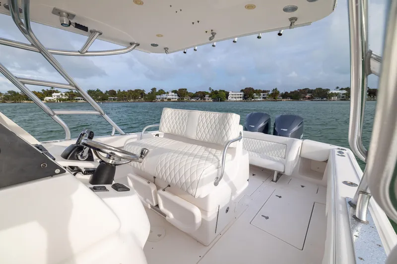Slide: The Image of 2011 Intrepid 370 Center Console boat interior with white seating and dual engines. - 20