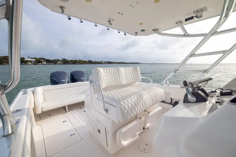 Slide: The Image of 2011 Intrepid 370 Center Console boat interior with luxurious seating and dual engines. - 21