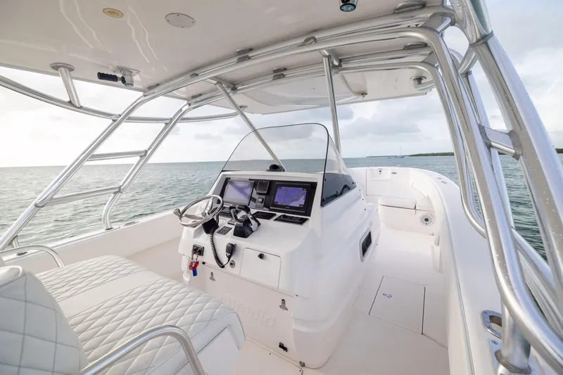 Slide: The Image of 2011 Intrepid 370 Center Console boat interior with navigation equipment, steering wheel, and ocean view. - 23