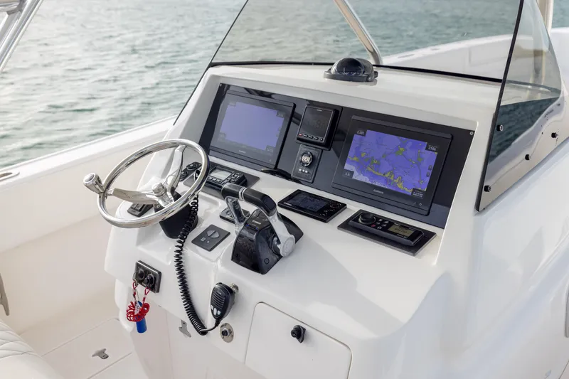 Slide: The Image of Control panel of a 2011 Intrepid 370 Center Console boat with navigation screens. - 25