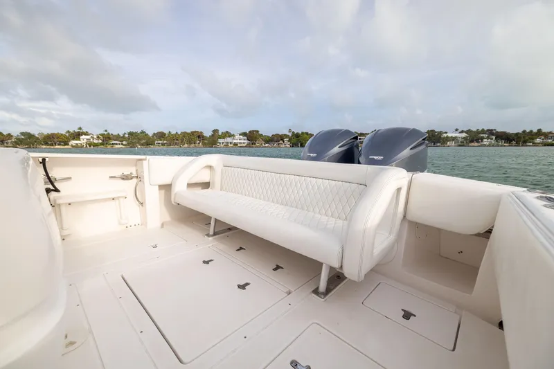 Slide: The Image of 2011 Intrepid 370 Center Console boat interior with white seating and dual engines. - 27
