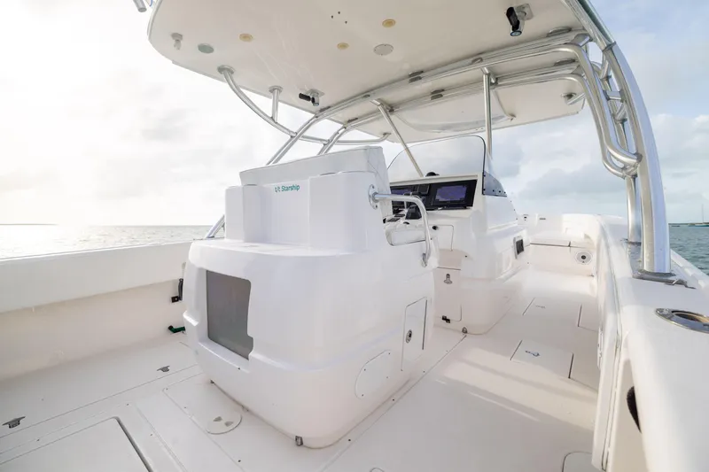 Slide: The Image of 2011 Intrepid 370 Center Console boat interior with helm, ocean view, and clear sky. - 30