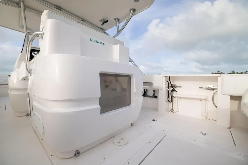 Slide: The Image of 2011 Intrepid 370 Center Console boat interior with white seating and storage compartments. - 31