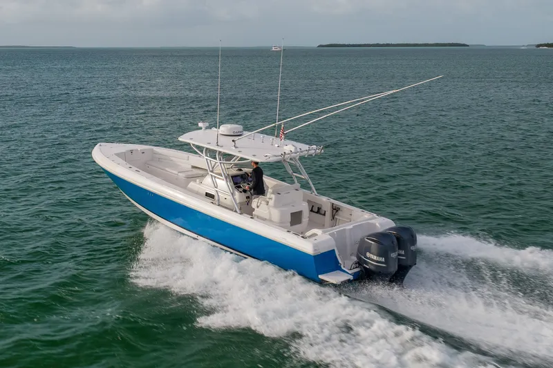 Slide: The Image of 2011 Intrepid 370 Center Console boat cruising on open water with twin Yamaha engines. - 7