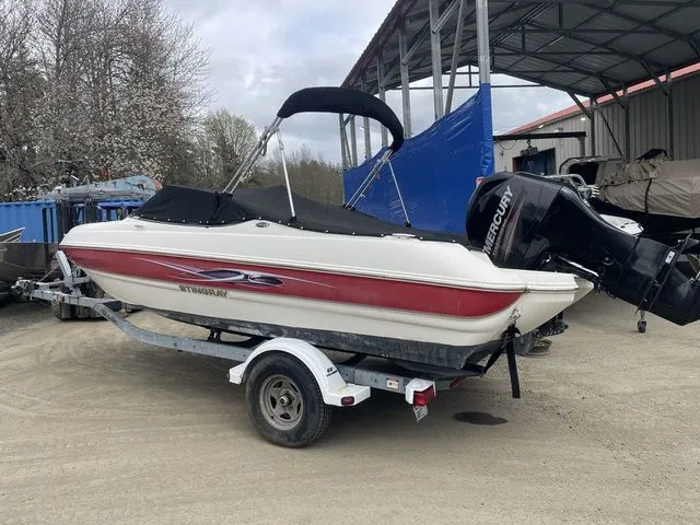 The Image of 2013 Stingray 194LX boat on trailer with outboard motor. - 1