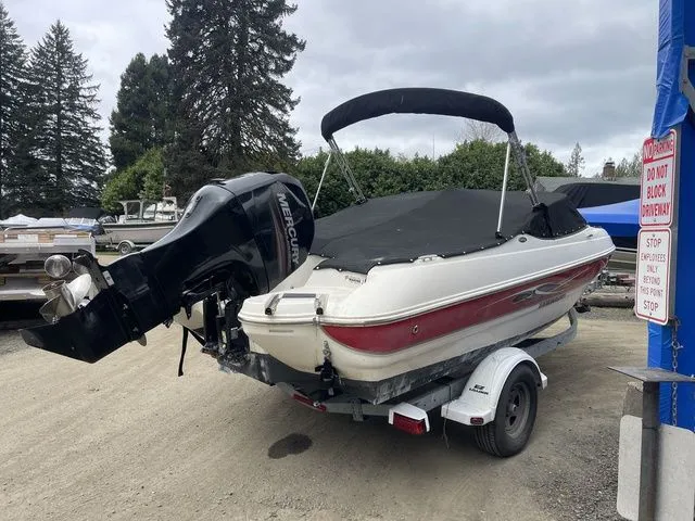 Slide: The Image of 2013 Stingray 194LX boat on trailer with cover. - 2