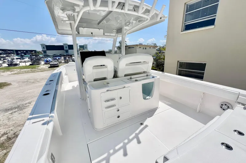 Slide: The Image of 2026 Stamas 33T Aventura boat interior with seating and storage, docked outdoors. - 10