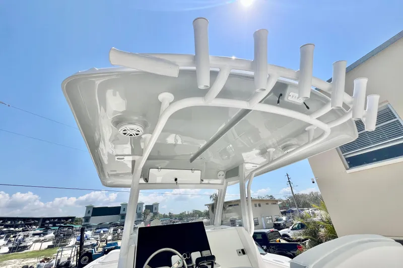 Slide: The Image of 2026 Stamas 33T Aventura boat with T-top and rod holders under sunny sky. - 15