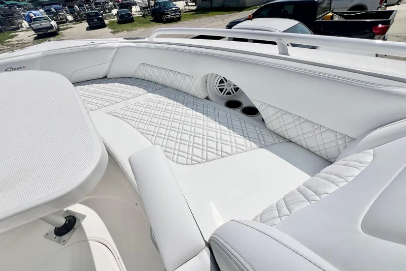 Slide: The Image of Luxurious seating on 2026 Stamas 33T Aventura boat, featuring white quilted upholstery and cup holders. - 24