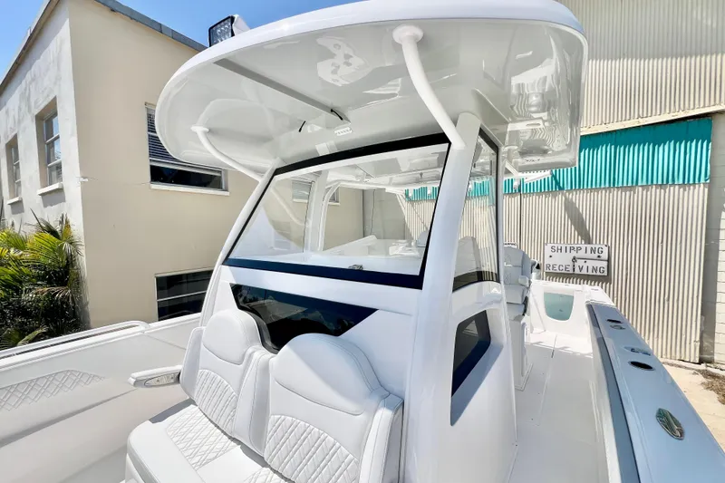 Slide: The Image of 2026 Stamas 33T Aventura boat with sleek design and modern features, docked near buildings. - 26