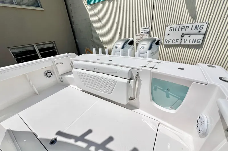 Slide: The Image of 2026 Stamas 33T Aventura boat deck with Suzuki engines, near shipping area. - 7