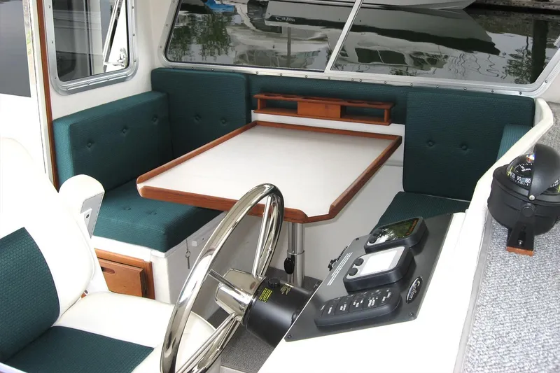 Slide: The Image of Interior of 2026 Sea Sport Sportsman 2200 boat with seating and navigation controls. - 3