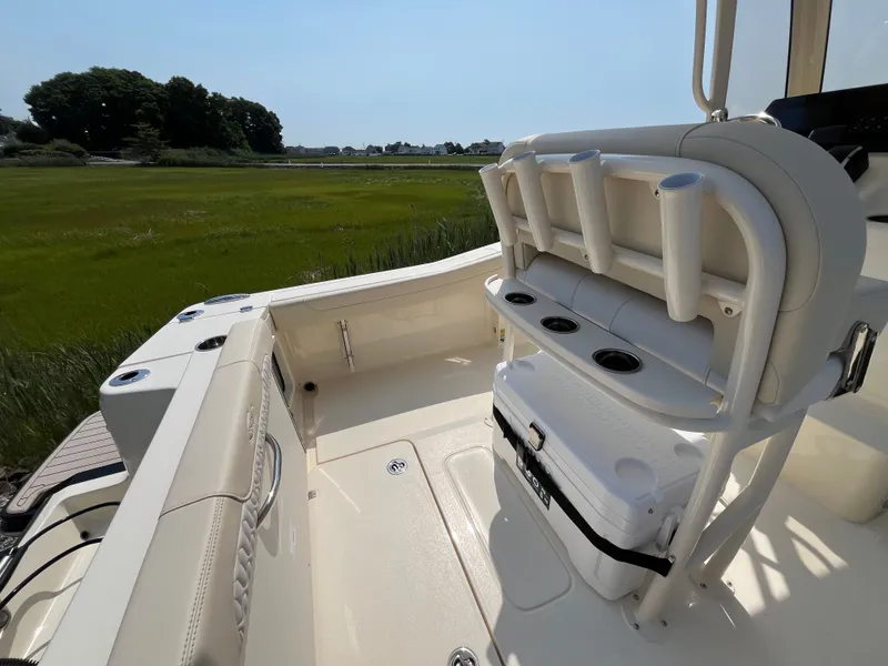 Slide: The Image of The boat features a light interior with rod holders and a cooler. - 5